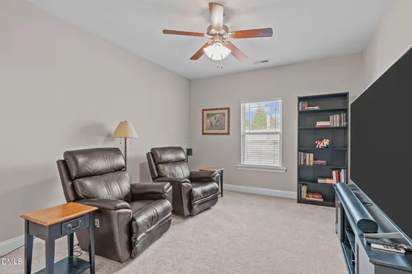 a living room with furniture a air conditioner and a window