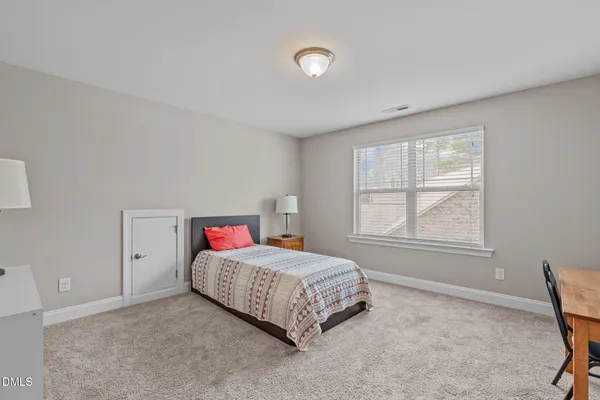 a living room with a bed and a table