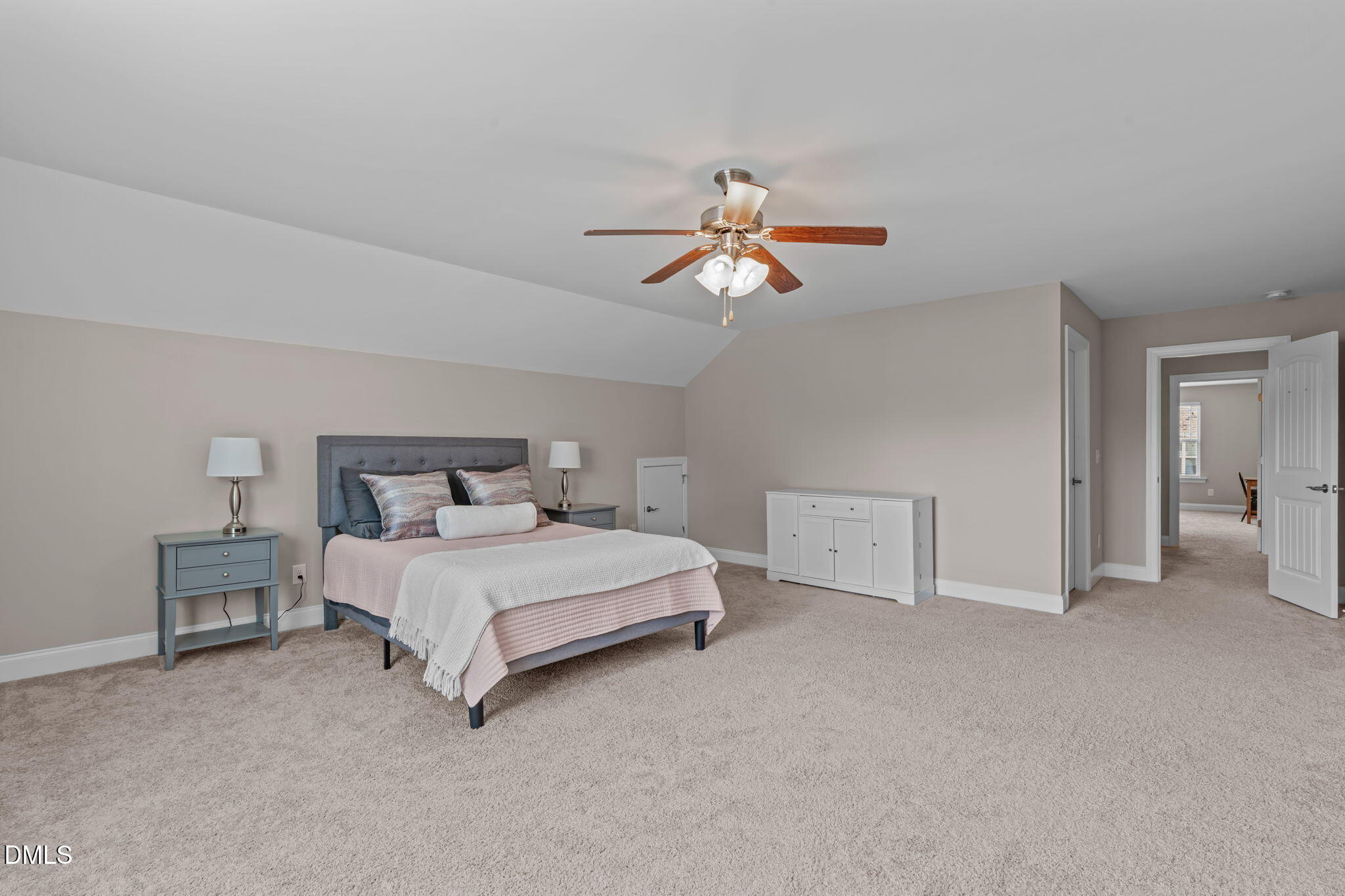90 Cypress Ridge Way. Willow Spring, NC 27592 - Photo 26 of 52 a spacious bedroom with a bed and a chandelier