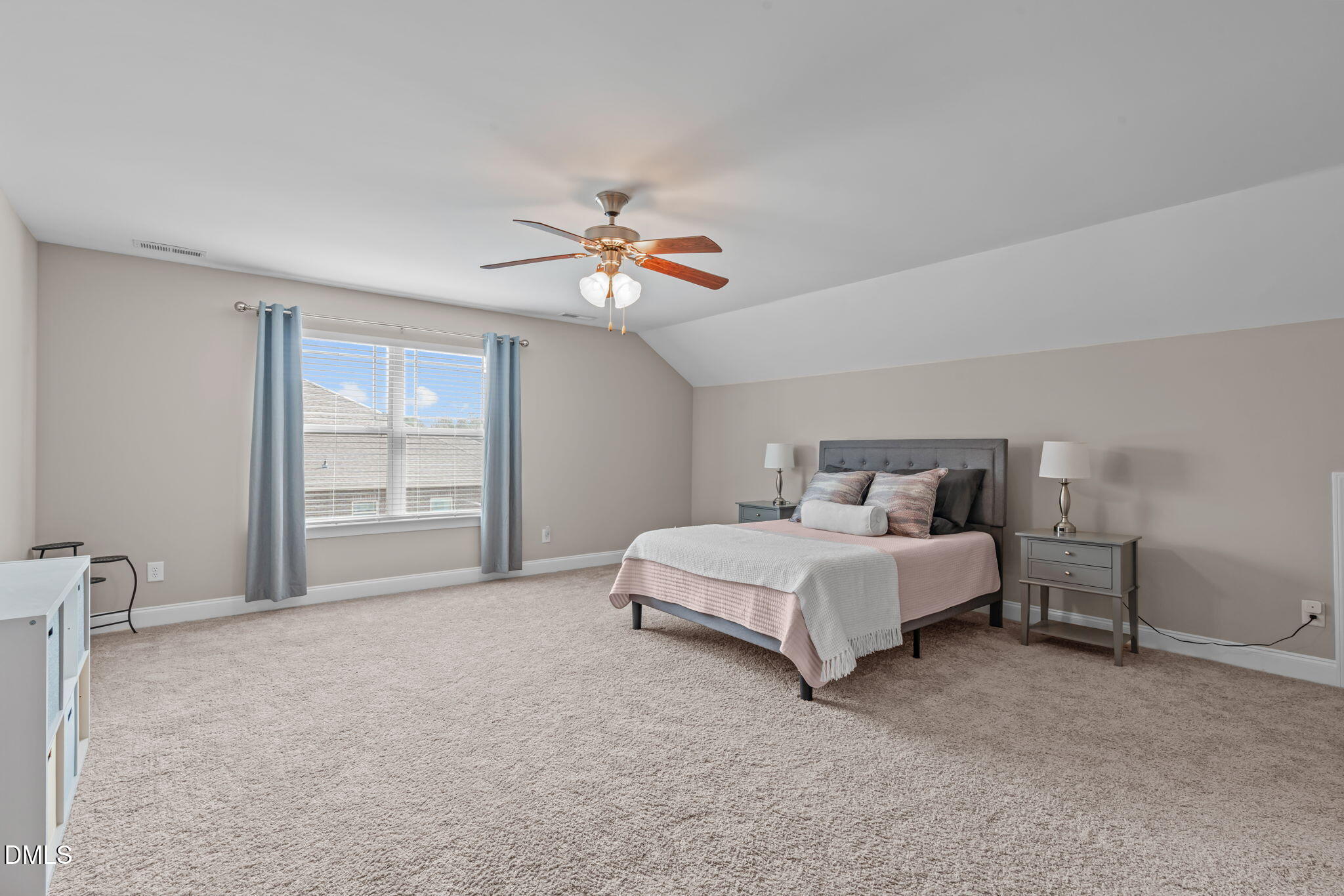 90 Cypress Ridge Way. Willow Spring, NC 27592 - Photo 27 of 52 a spacious bedroom with a bed and a chandelier