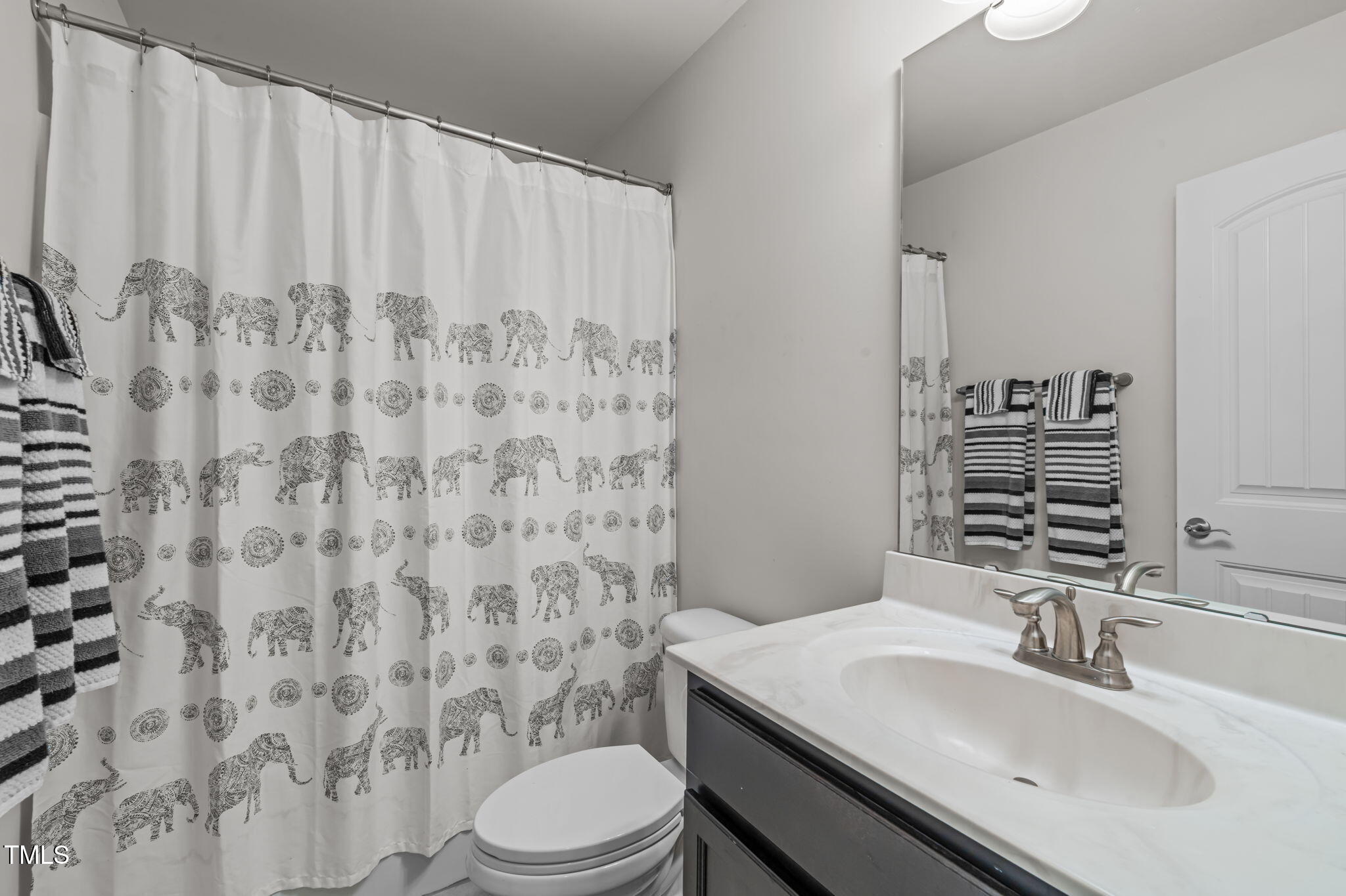 90 Cypress Ridge Way. Willow Spring, NC 27592 - Photo 28 of 52 a bathroom with a sink toilet and shower