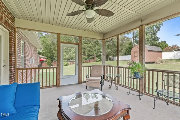 a balcony with furniture and wooden floor