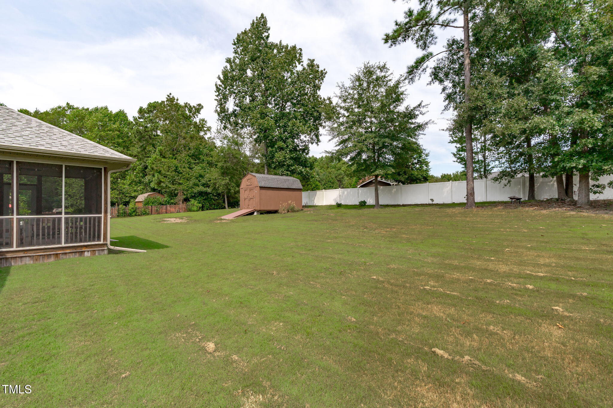 90 Cypress Ridge Way. Willow Spring, NC 27592 - Photo 42 of 52 a view of a house with backyard outdoor seating and trees