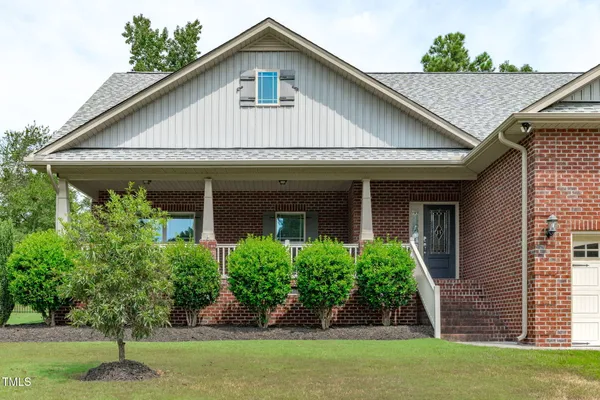 a view of a house with backyard outdoor seating and trees