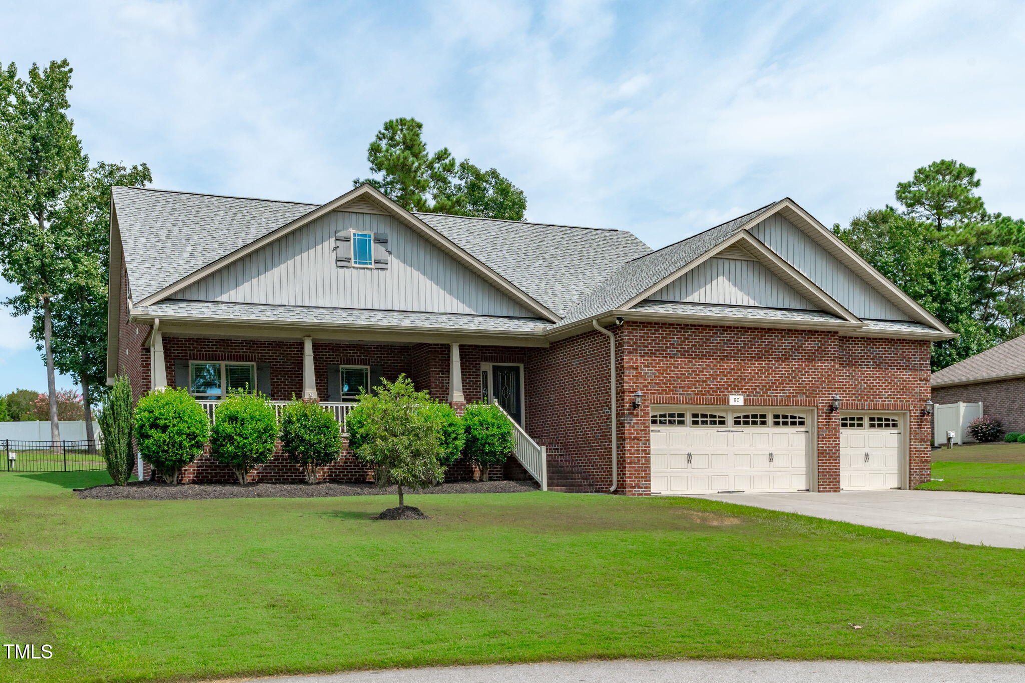 90 Cypress Ridge Way. Willow Spring, NC 27592 - Photo 45 of 52 a front view of a house with a yard and garage