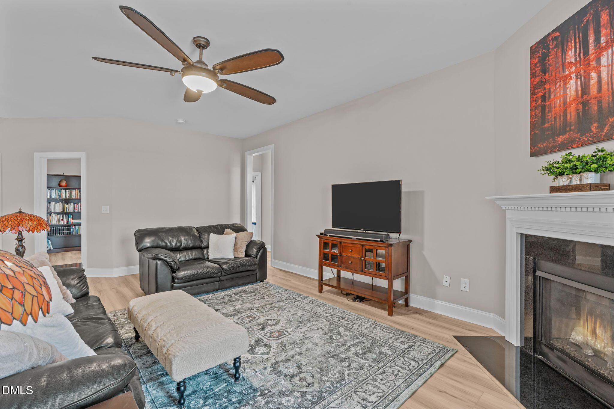 90 Cypress Ridge Way. Willow Spring, NC 27592 - Photo 7 of 52 a living room with furniture a flat screen tv and a fireplace