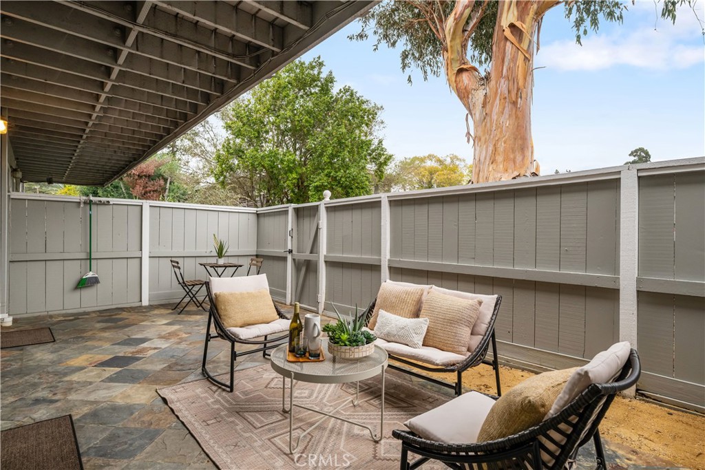 61 Pixley Avenue, Unit 3 Corte Madera, CA 94925 - Photo 15 of 17 a view of a patio with a table and chairs under an umbrella with a barbeque