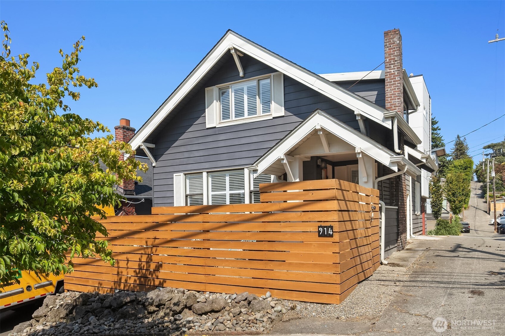 914 West Howe Street Seattle, WA 98119 - Photo 26 of 29 a view of a house with a small yard and potted plants