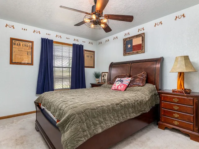 a bathroom with a granite countertop sink a toilet and a mirror