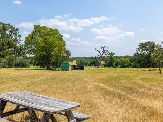 a view of yard with swimming pool and trees