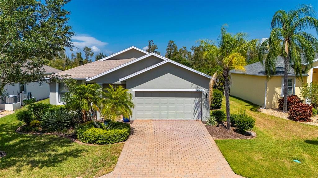 24604 Rio Villa Lakes Circle Punta Gorda, FL 33950 - Photo 1 of 28 a front view of a house with a yard garage and outdoor seating