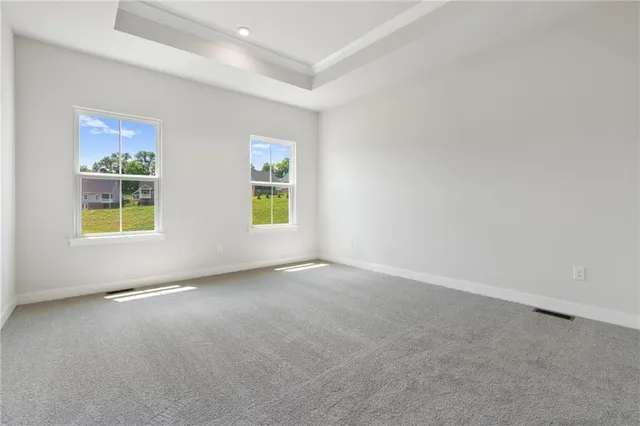 an empty room with windows and entrance