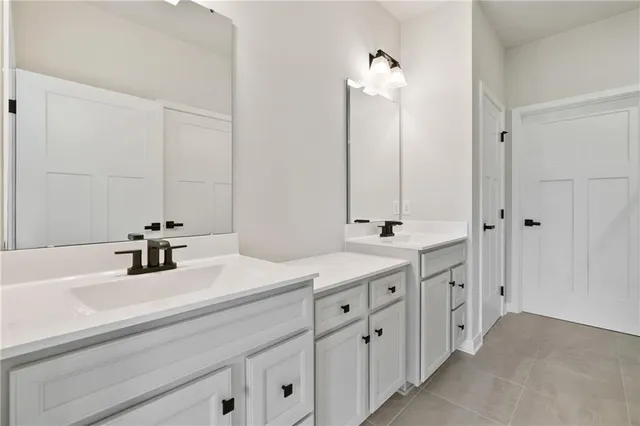 a bathroom with a double vanity sink mirror and