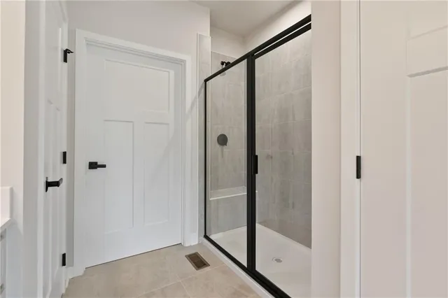 a bathroom with a glass shower door