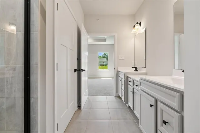 a bathroom with a double vanity sink and mirror