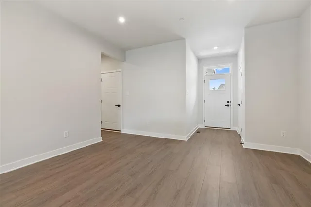 an empty room with wooden floor