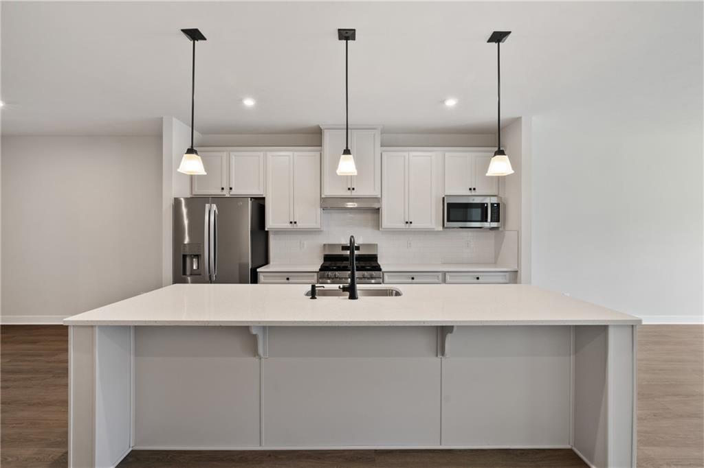 113 Olivia Drive Eighty Four, PA 15330 - Photo 5 of 29 a kitchen with kitchen island a counter top space appliances and cabinets