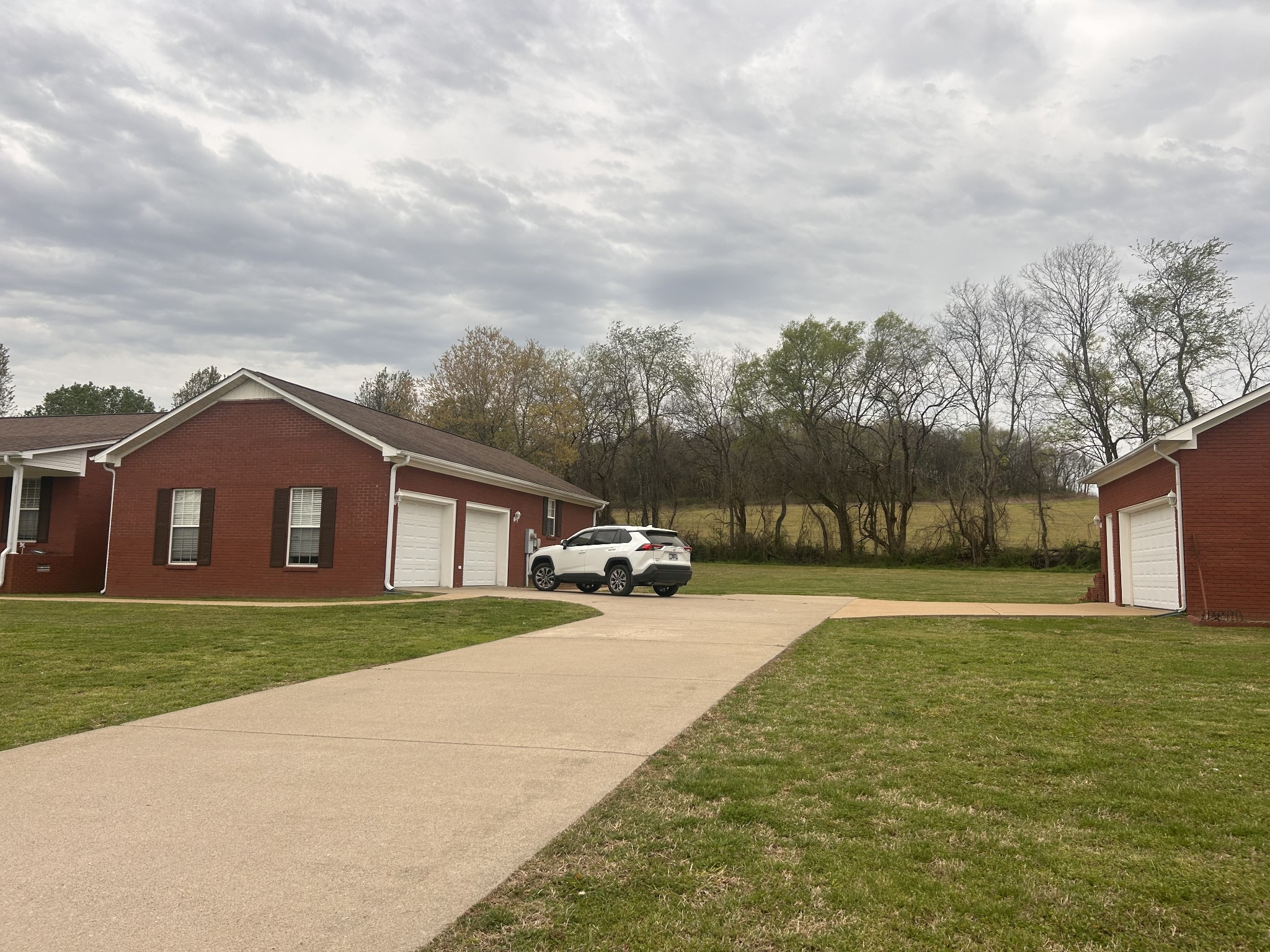 2200 Crescentview Road Pulaski, TN 38478 - Photo 4 of 72 a view of a yard in front of a house with large trees