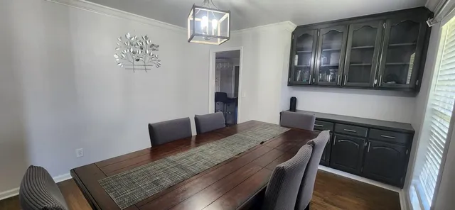 a kitchen with a sink a stove a dining table and chairs