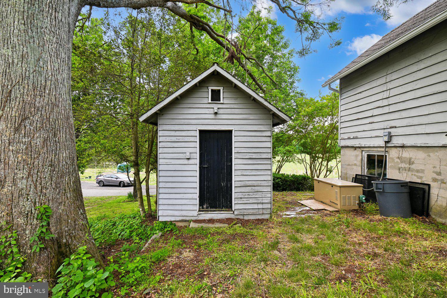 17401 Milltown Landing Road Brandywine, MD 20613 - Photo 78 of 96 Charming shed nestled among lush greenery.