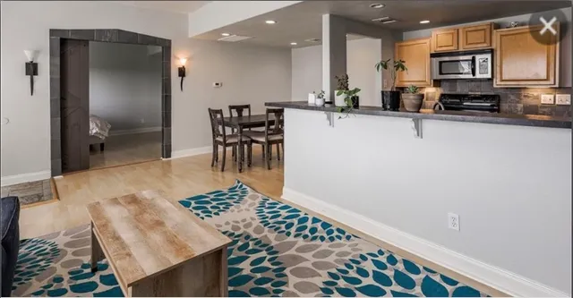 a kitchen with stainless steel appliances granite countertop a refrigerator and a sink