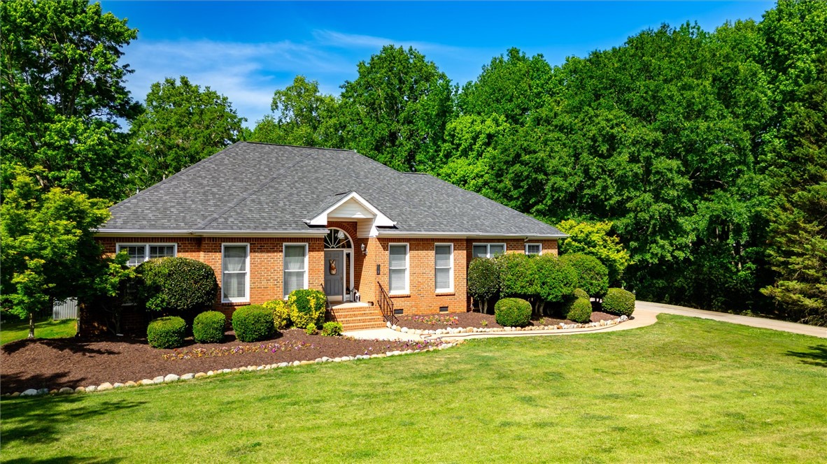117 Winding Creek Road Anderson, SC 29621 - Photo 2 of 42 This classic brick residence is nestled amongst lush greenery, offering a serene curb appeal.