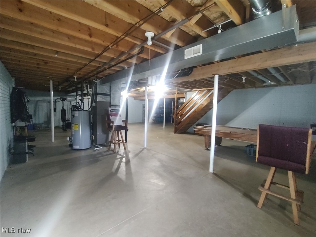 870 Susan Road Ravenna, OH 44266 - Photo 31 of 35 Unfinished basement with stairs and water heater
