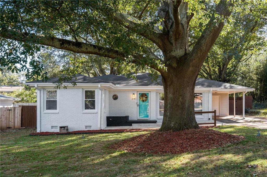 3141 Robin Road Decatur, GA 30032 - Photo 1 of 1 a house that has a tree in front of a white house