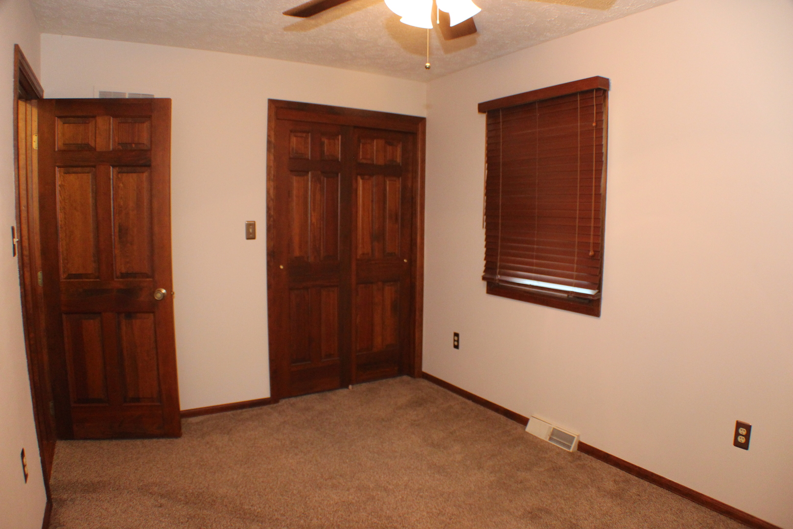 8 Apache Court Eldridge, IA 52748 - Photo 15 of 29 an empty room with windows closet and chandelier fan