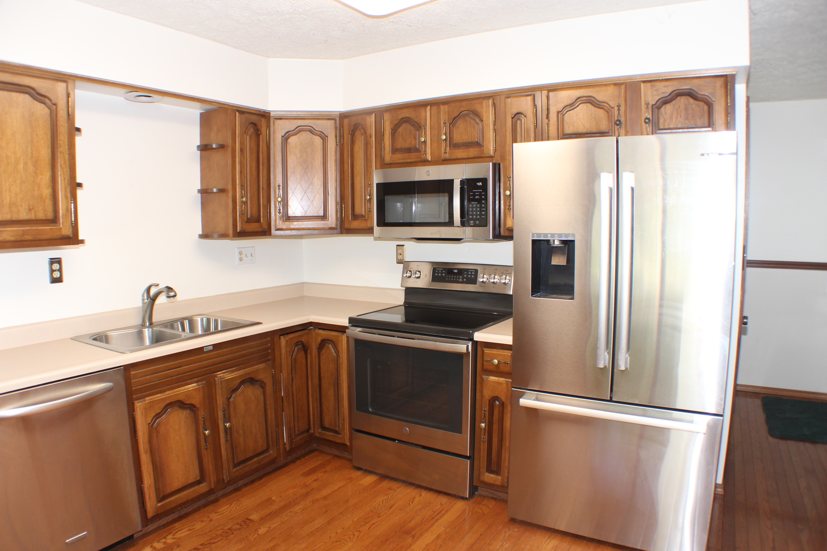 8 Apache Court Eldridge, IA 52748 - Photo 2 of 29 a kitchen with stainless steel appliances granite countertop a refrigerator a stove a sink and a microwave