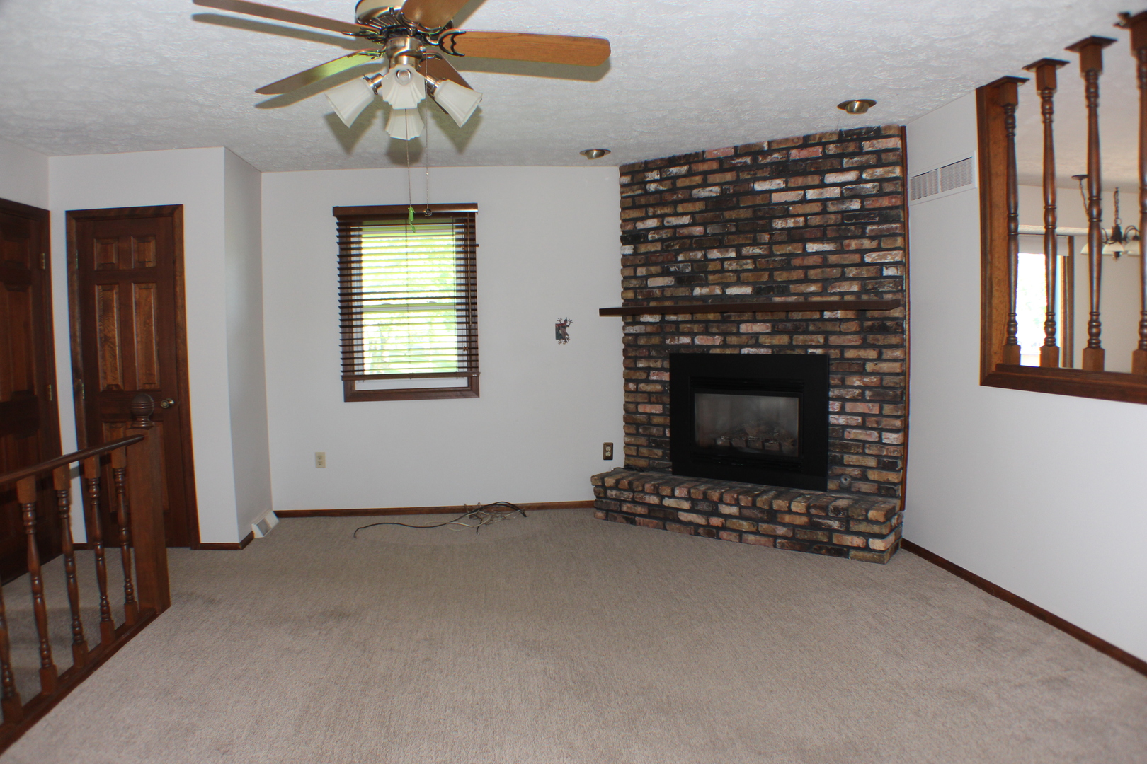 8 Apache Court Eldridge, IA 52748 - Photo 7 of 29 a view of an empty room with a fireplace and a window