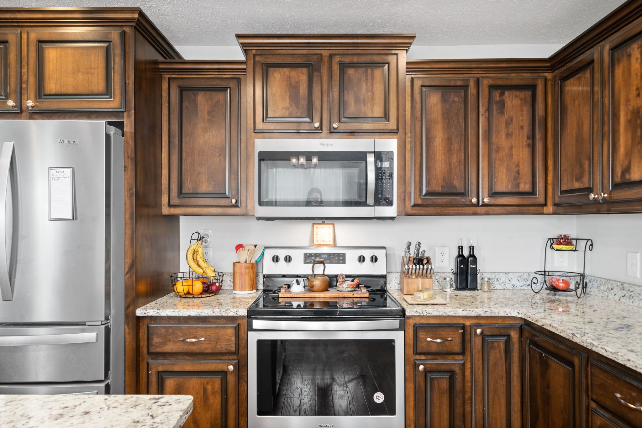 209 Northup Road Portland, TN 37148 - Photo 11 of 39 a kitchen with stainless steel appliances granite countertop a stove a microwave and refrigerator