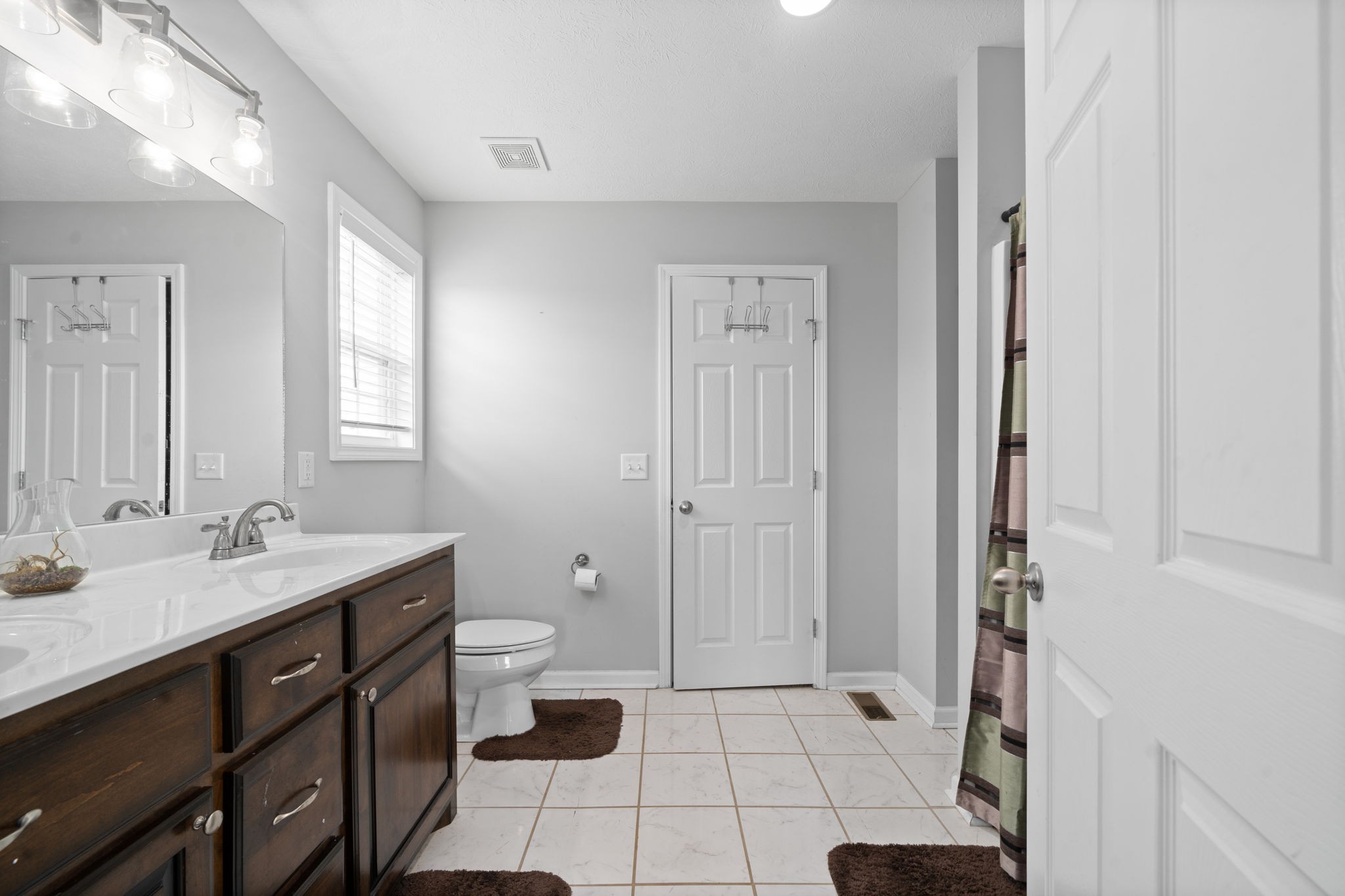 209 Northup Road Portland, TN 37148 - Photo 16 of 39 a spacious bathroom with a sink a toilet a mirror and shower