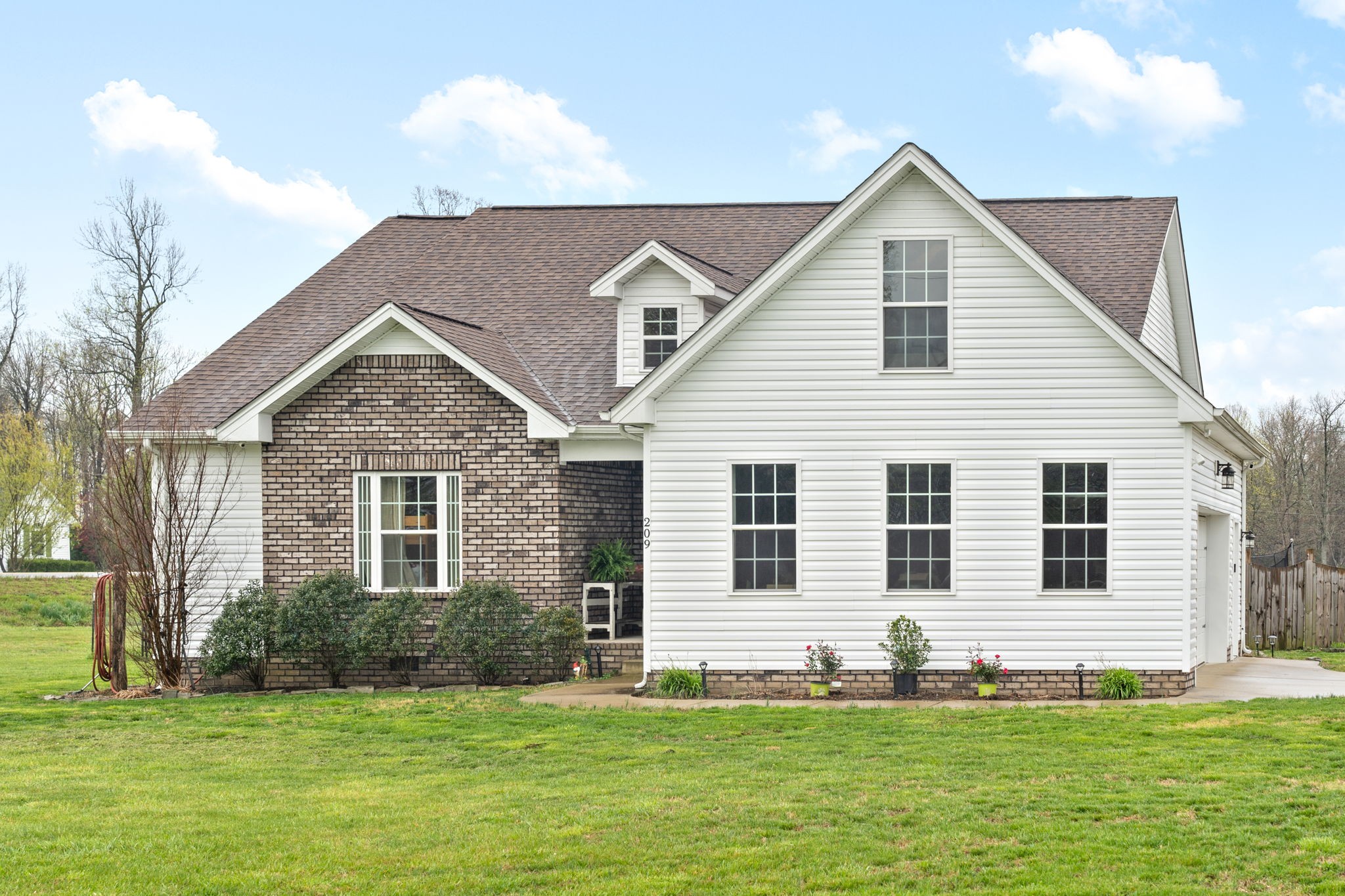 209 Northup Road Portland, TN 37148 - Photo 2 of 39 a front view of a house with a yard and garage