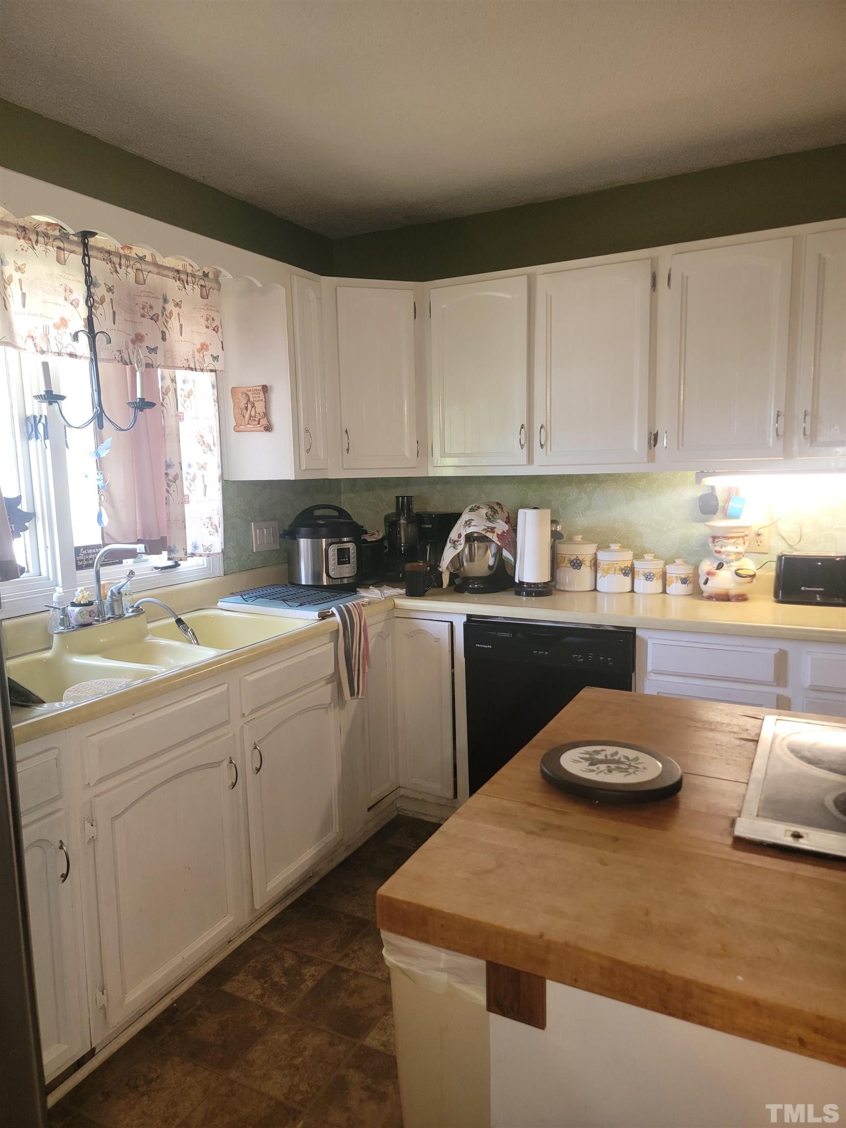 5360 Packhouse Road Wilson, NC 27896 - Photo 6 of 9 a kitchen with a sink a stove and white cabinets