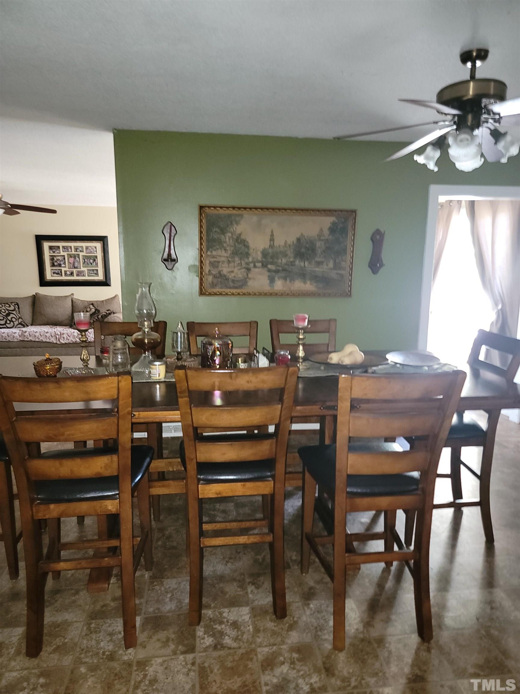 5360 Packhouse Road Wilson, NC 27896 - Photo 7 of 9 a view of a dining room with furniture and a chandelier