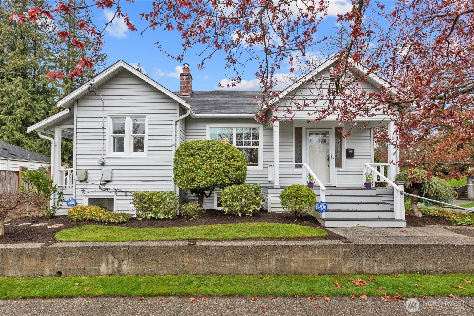 2857 Northwest 73rd Street Seattle, WA 98117 - Photo 1 of 25 a front view of a house with a yard