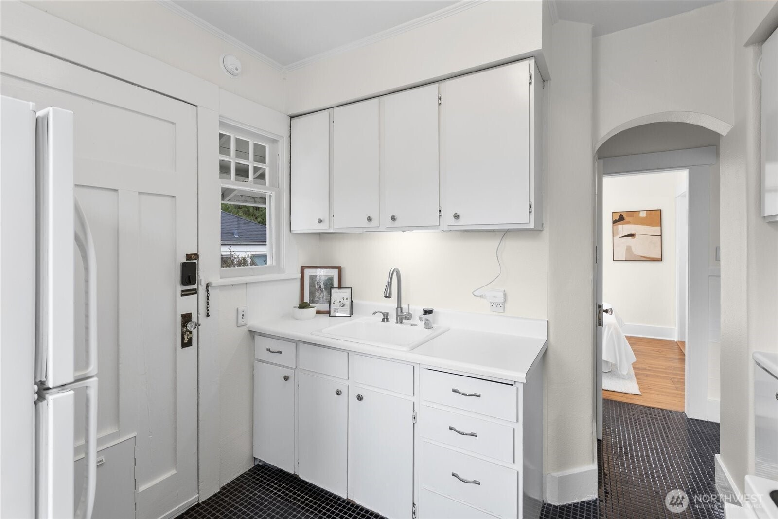 2857 Northwest 73rd Street Seattle, WA 98117 - Photo 12 of 25 a kitchen with stainless steel appliances a sink and cabinets