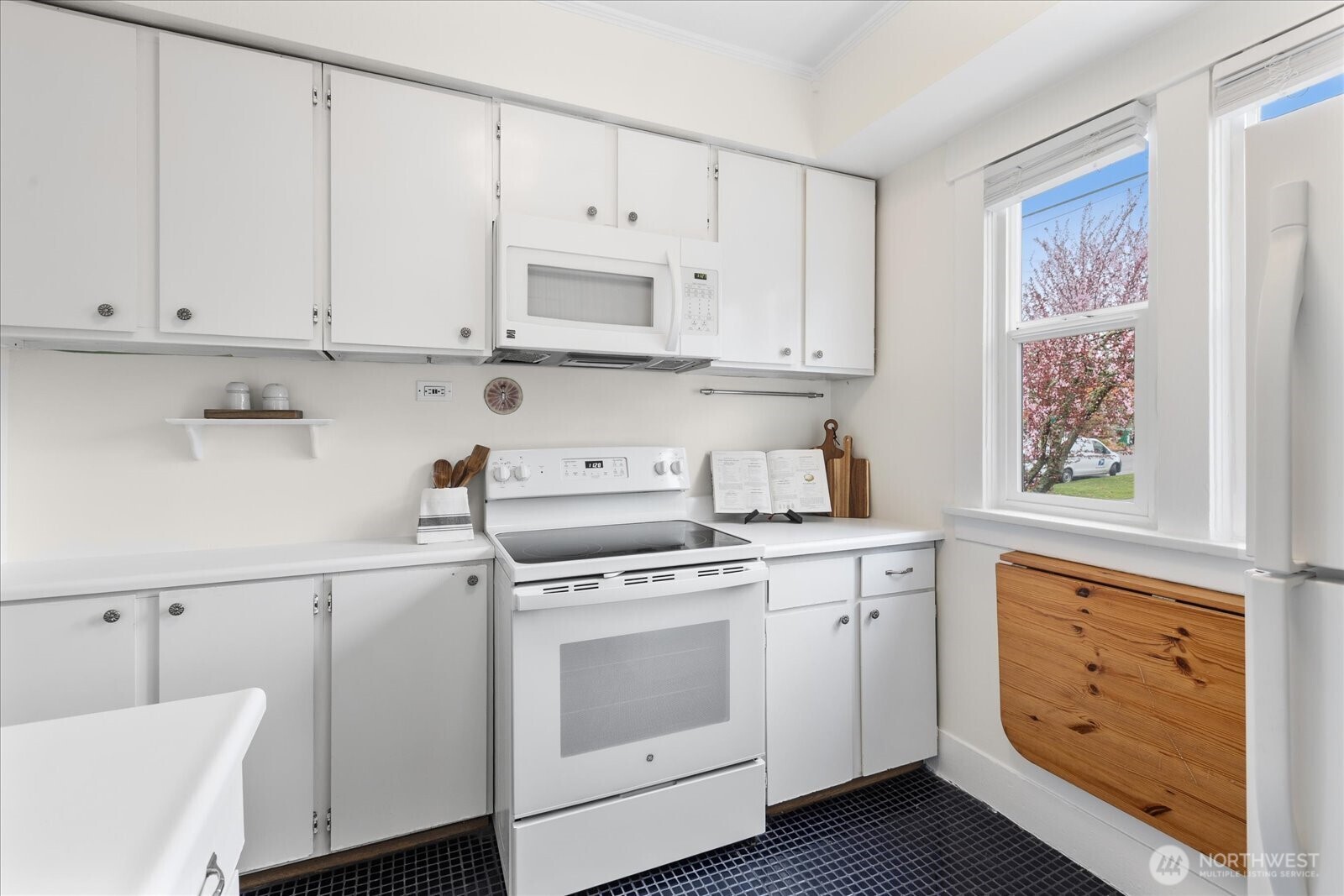 2857 Northwest 73rd Street Seattle, WA 98117 - Photo 13 of 25 a kitchen with cabinets appliances a sink and a window