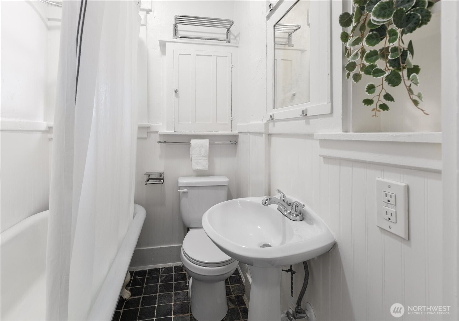 2857 Northwest 73rd Street Seattle, WA 98117 - Photo 9 of 25 a bathroom with a sink a toilet and a mirror