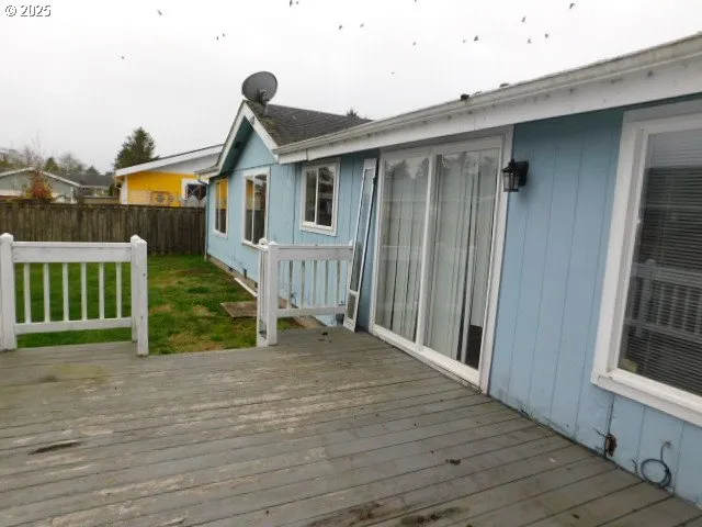 a view of a house with wooden fence
