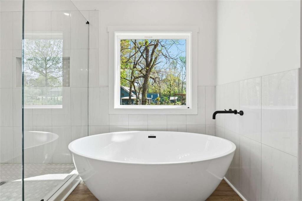 11691 Hazelbrand Road Northeast Covington, GA 30014 - Photo 36 of 53 a white bath tub sitting in a bathroom next to a window