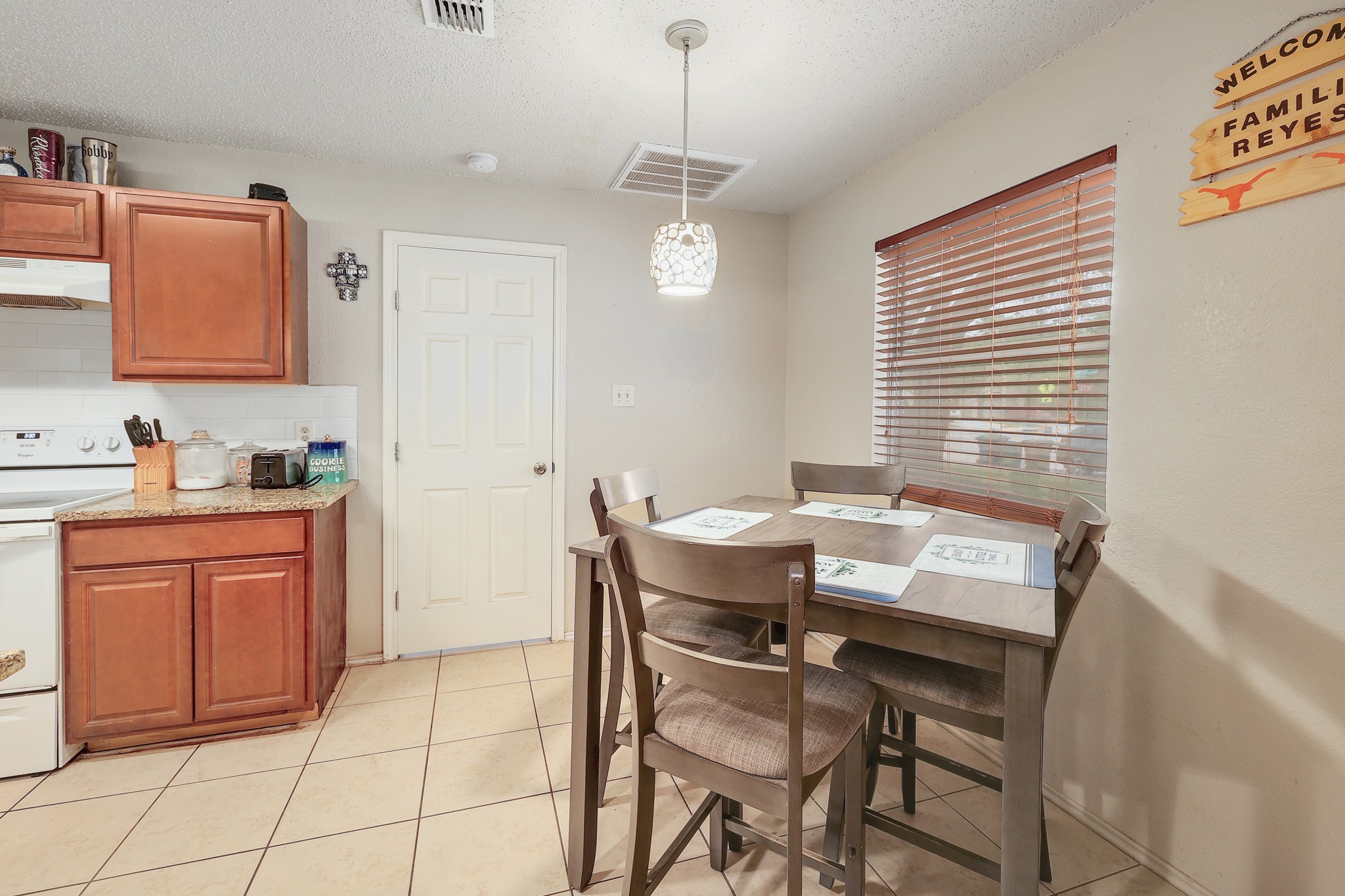 9901 Parliament House Road Austin, TX 78729 - Photo 11 of 40 Dining area with a textured ceiling and light tile patterned floors