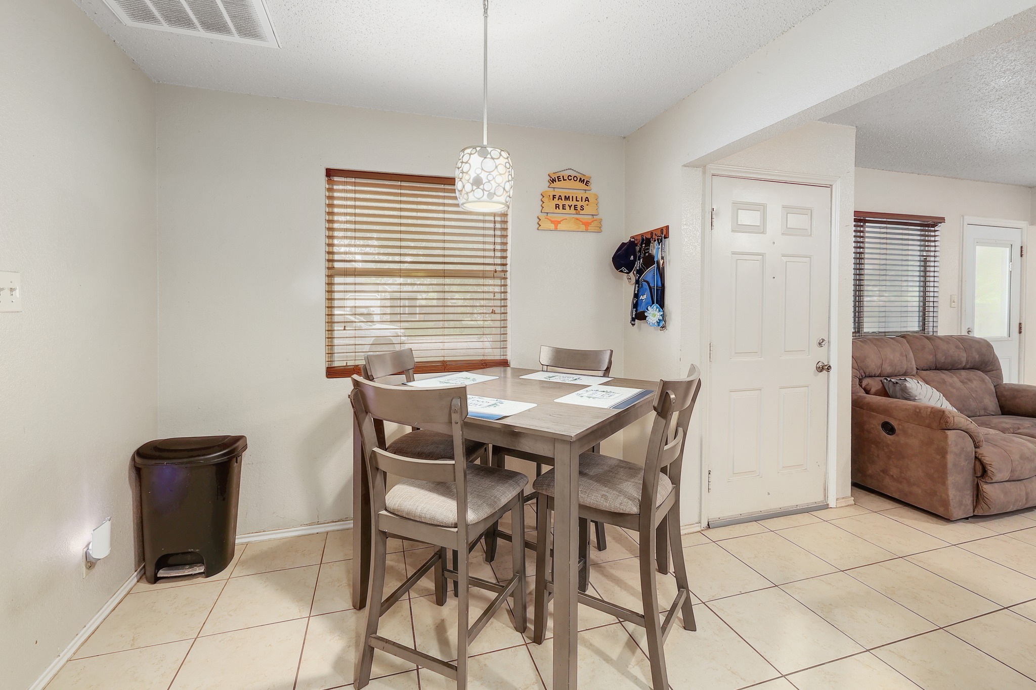 9901 Parliament House Road Austin, TX 78729 - Photo 12 of 40 Dining room with a textured ceiling, light tile patterned floors, and healthy amount of natural light