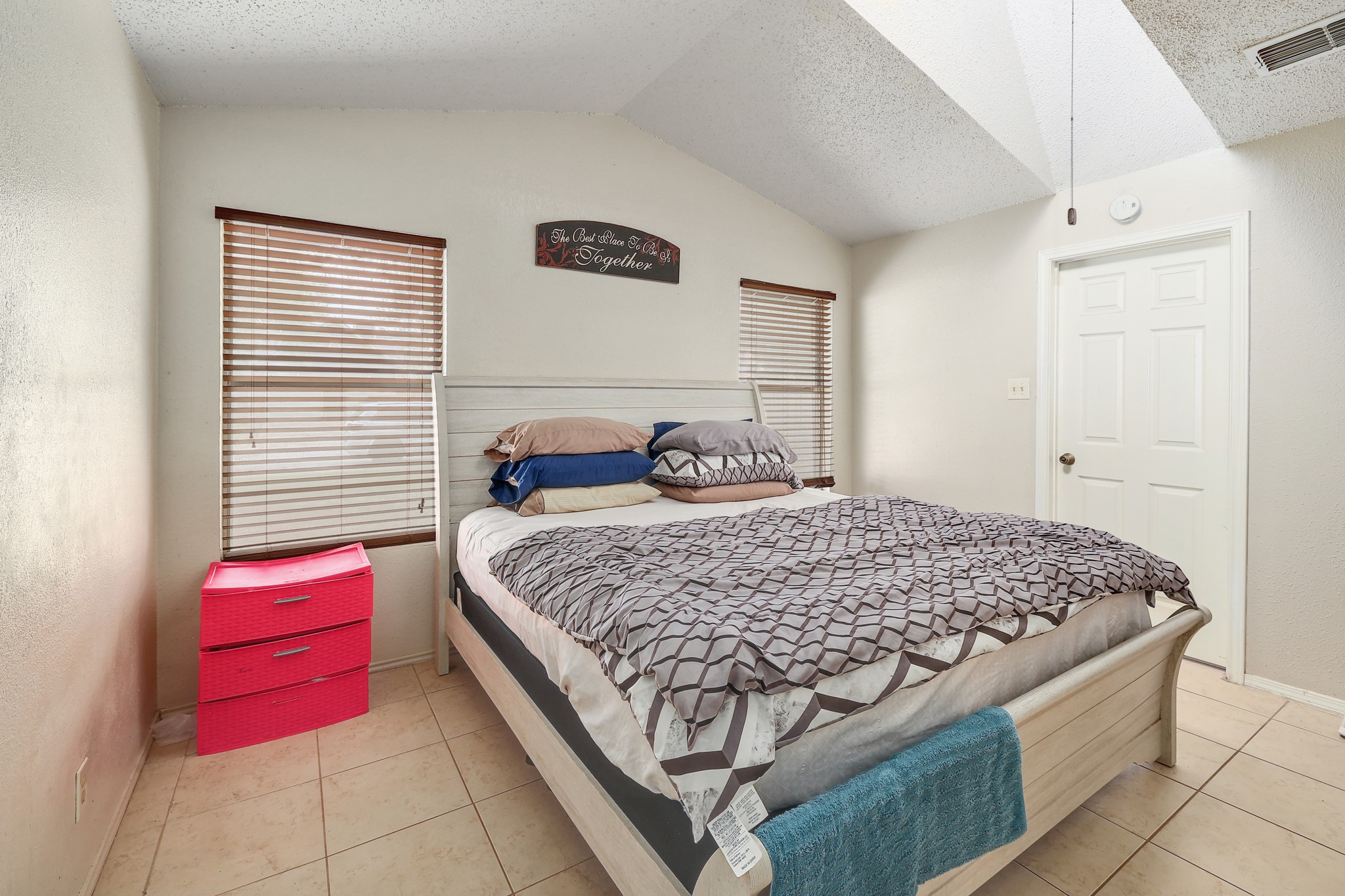 9901 Parliament House Road Austin, TX 78729 - Photo 13 of 40 Bedroom with light tile patterned floors and a textured wall