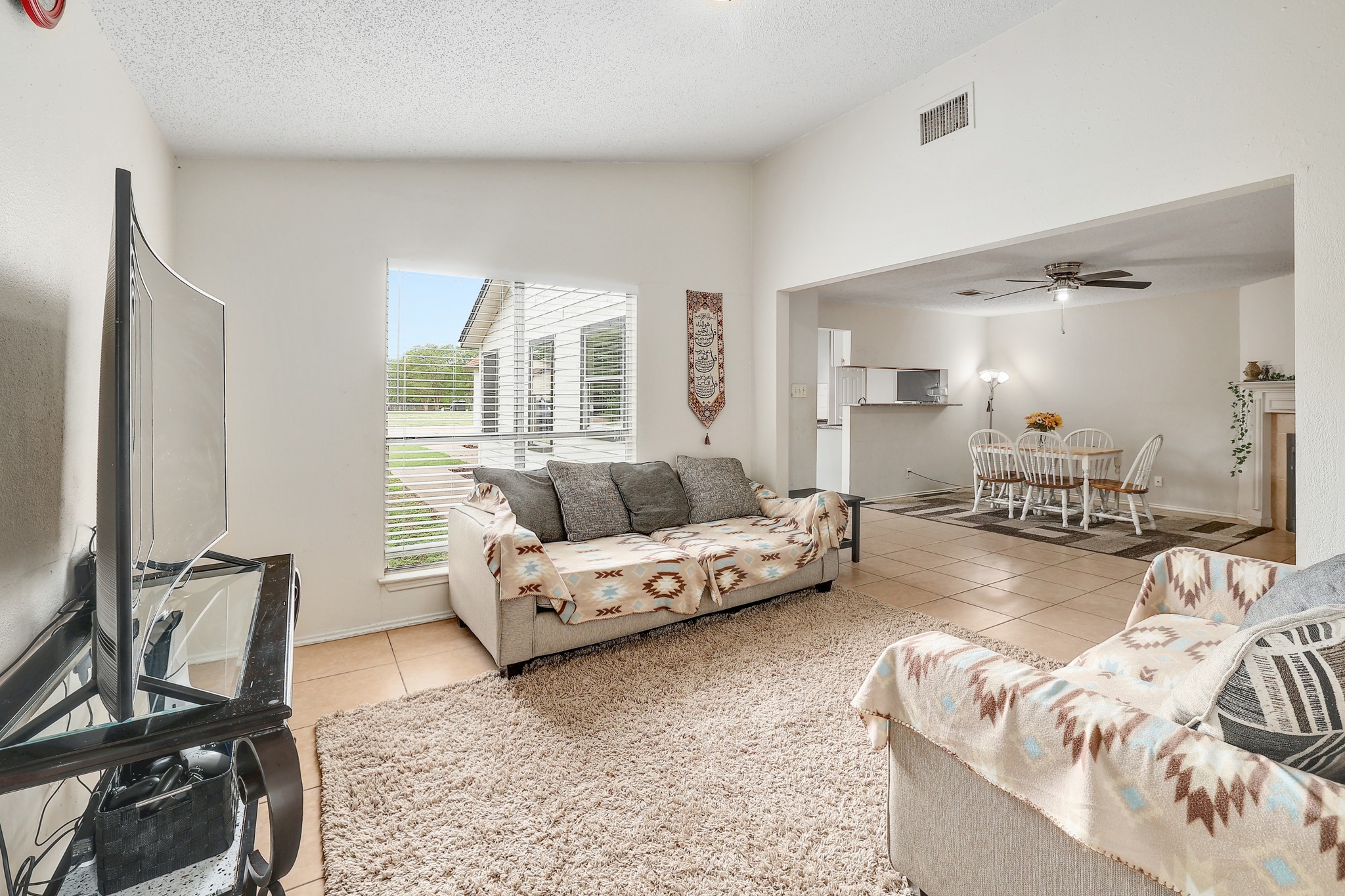 9901 Parliament House Road Austin, TX 78729 - Photo 23 of 40 Living room with light tile patterned floors and a ceiling fan