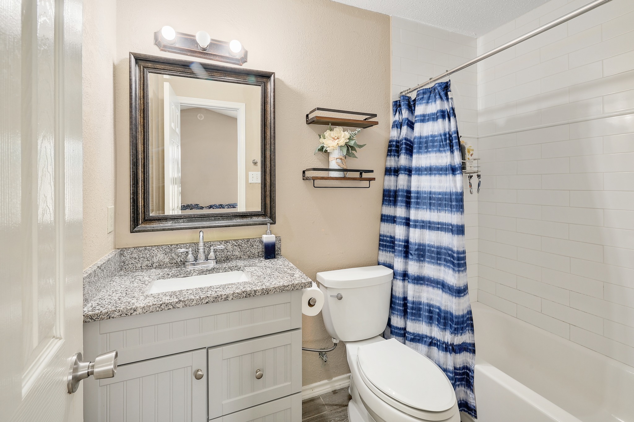 9901 Parliament House Road Austin, TX 78729 - Photo 27 of 40 Full bathroom with vanity and shower / bath combination with curtain