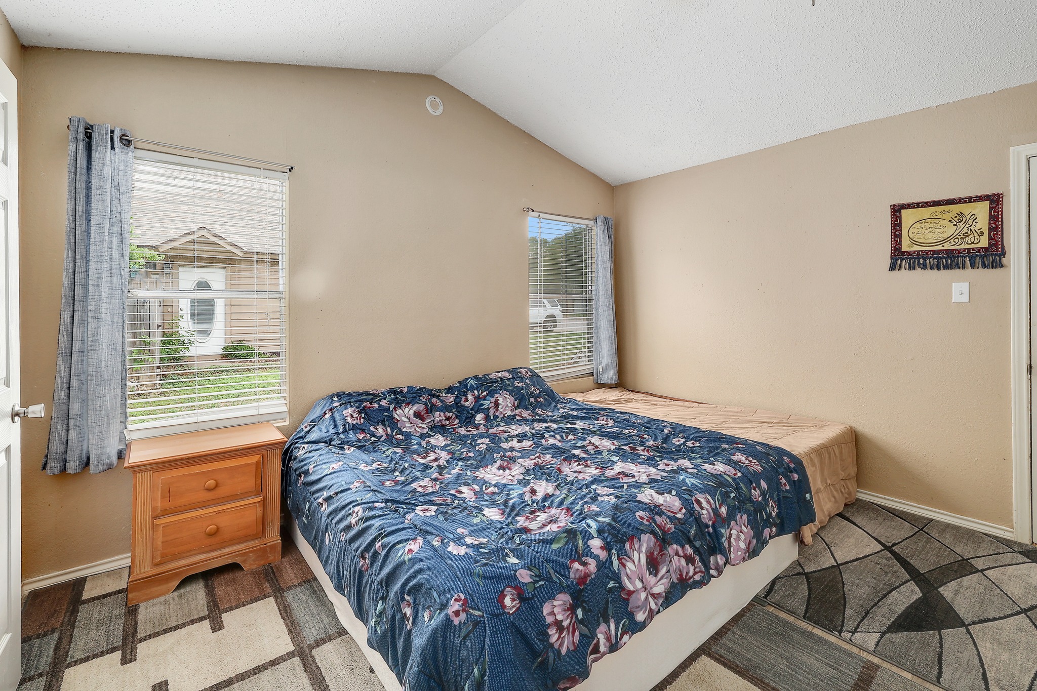9901 Parliament House Road Austin, TX 78729 - Photo 28 of 40 Bedroom with baseboards and lofted ceiling
