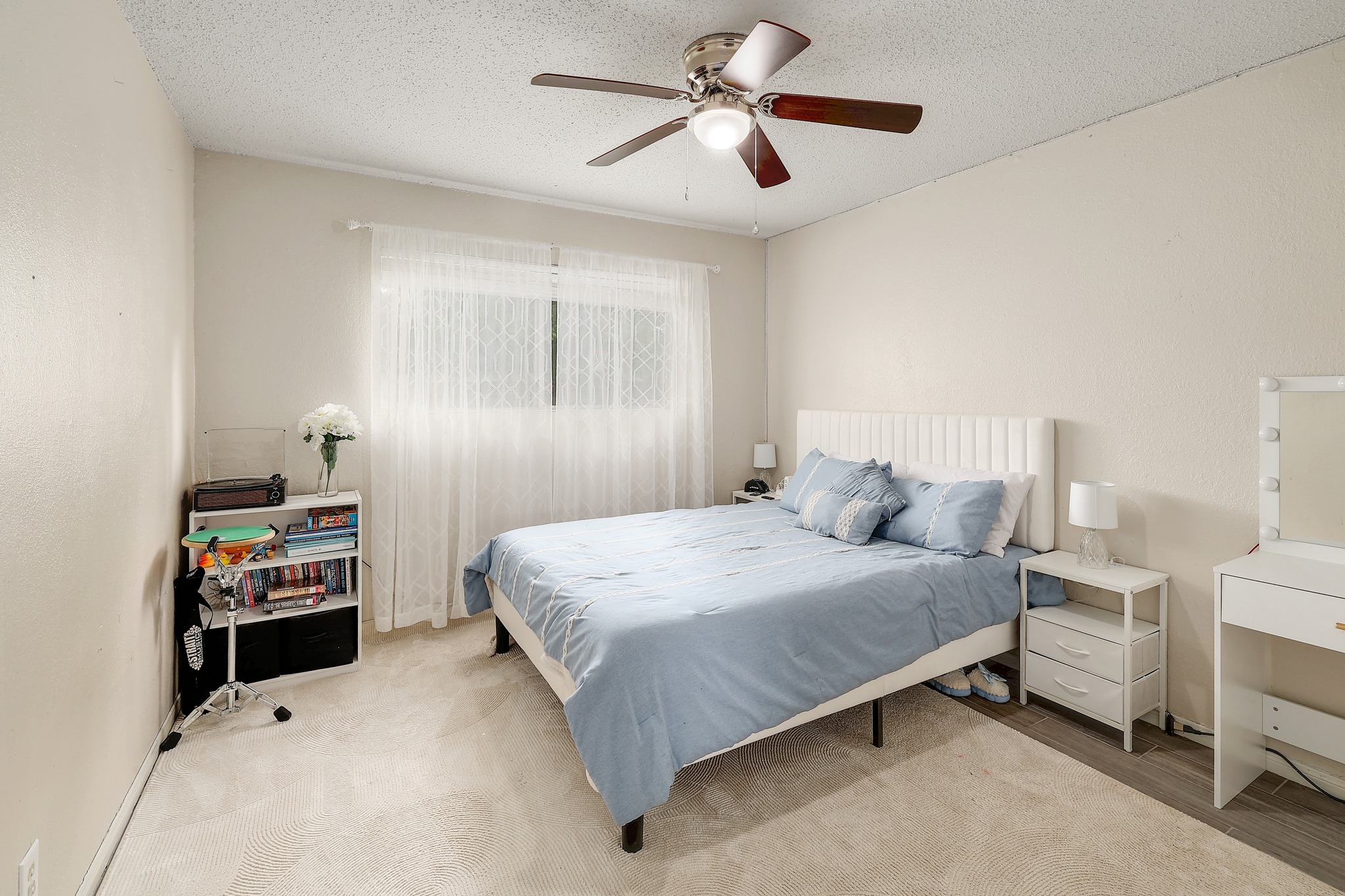 9901 Parliament House Road Austin, TX 78729 - Photo 30 of 40 Bedroom featuring a ceiling fan and a textured ceiling