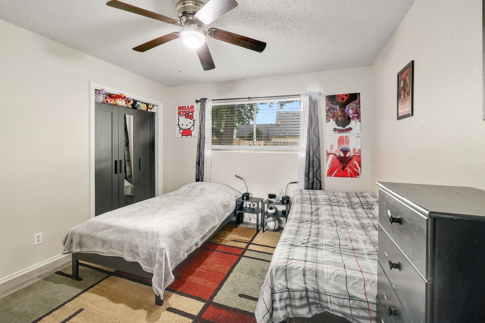 9901 Parliament House Road Austin, TX 78729 - Photo 31 of 40 Bedroom with ceiling fan and a textured ceiling